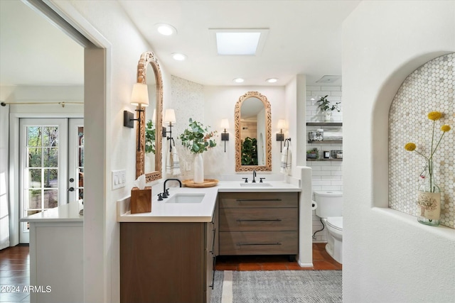 bathroom featuring vanity, wood-type flooring, and toilet