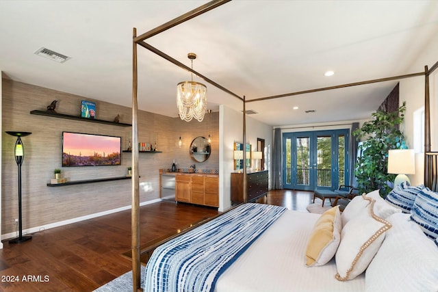 bedroom with a notable chandelier, dark wood-type flooring, and french doors