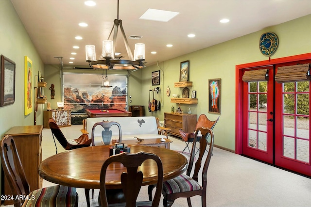 dining room featuring light colored carpet and a notable chandelier