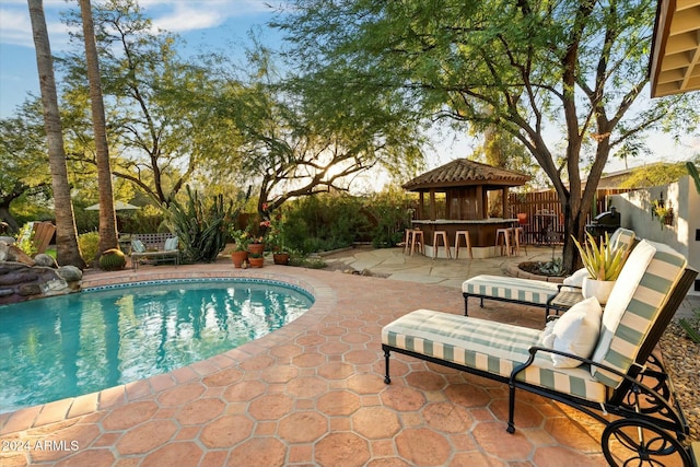 view of swimming pool with a gazebo, an outdoor bar, and a patio