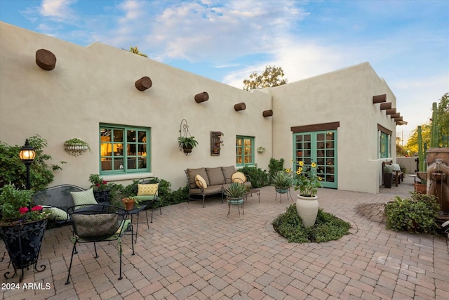 view of patio / terrace with an outdoor living space and french doors