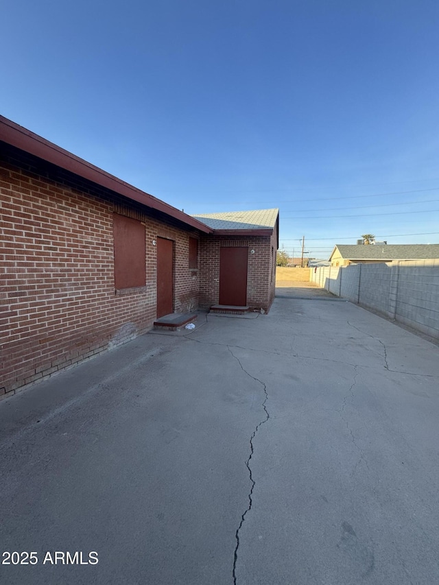 view of side of home with a patio area