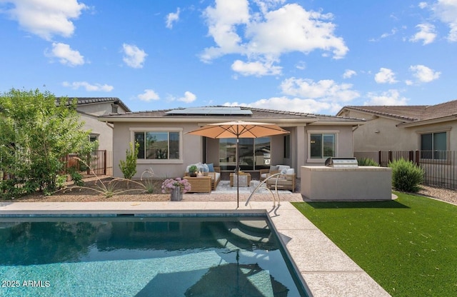 back of house with a fenced backyard, an outdoor living space, a fenced in pool, roof mounted solar panels, and a patio area