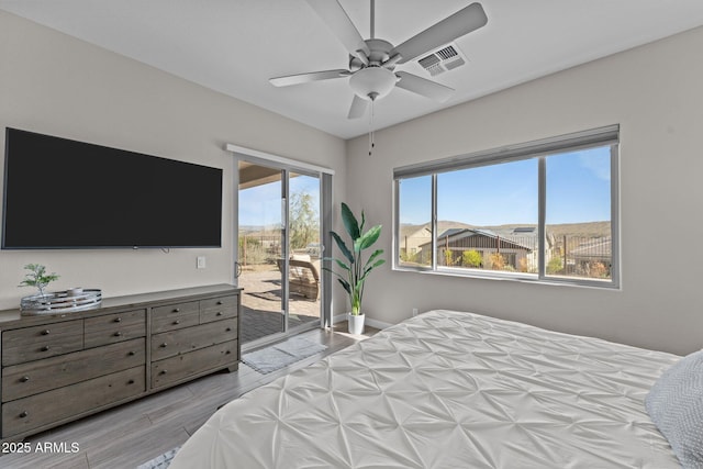 bedroom with ceiling fan, visible vents, baseboards, access to outside, and light wood-type flooring