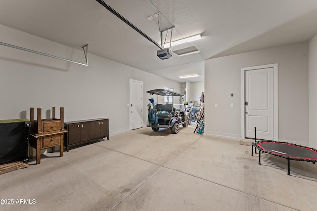 garage featuring baseboards and a garage door opener