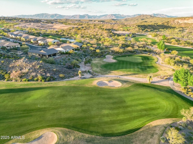 drone / aerial view featuring view of golf course and a mountain view