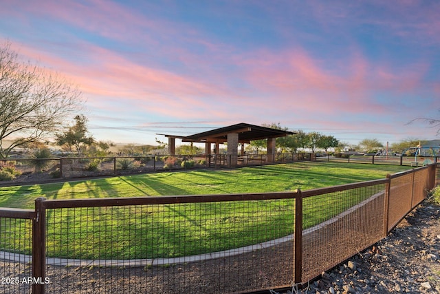 view of home's community with a yard and fence