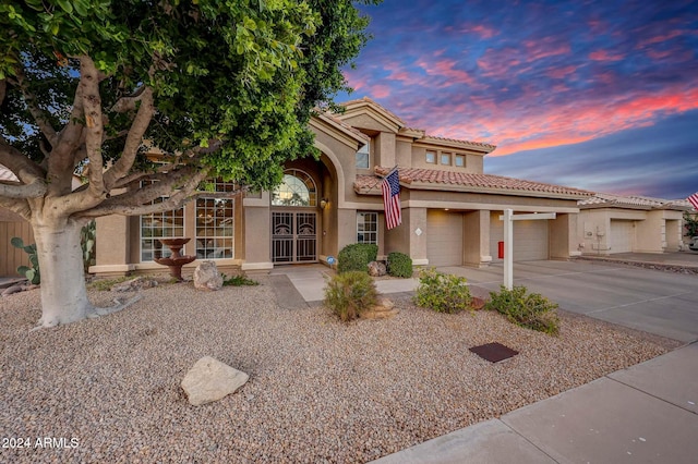 mediterranean / spanish-style home with a garage