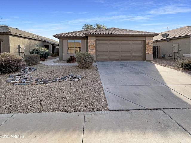 view of front facade with a tile roof, stucco siding, concrete driveway, an attached garage, and stone siding