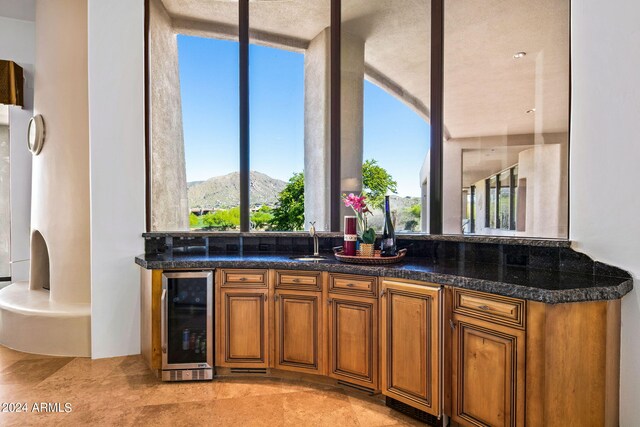 kitchen featuring a mountain view, sink, and beverage cooler