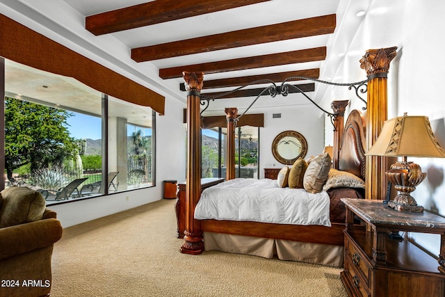 bedroom featuring beam ceiling and carpet floors