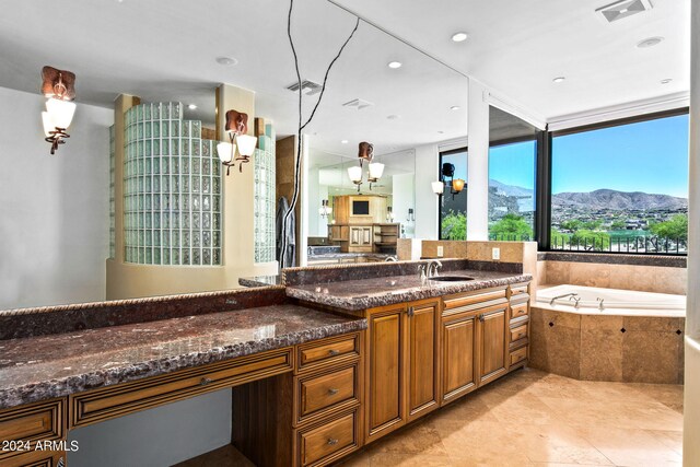 bathroom with tile patterned floors, floor to ceiling windows, vanity, tiled tub, and a mountain view