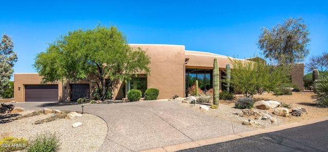 southwest-style home with a garage