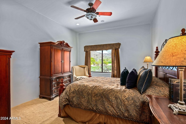 bedroom with ceiling fan and light colored carpet