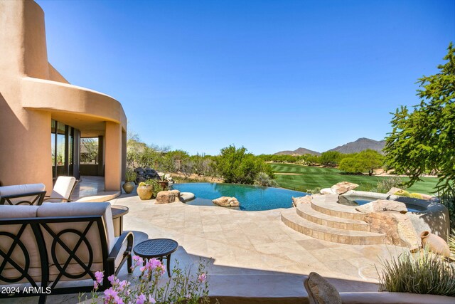 view of pool with a mountain view and a patio