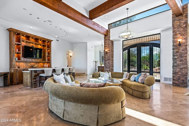 living room with beam ceiling and a towering ceiling