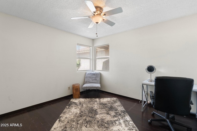 home office featuring a textured ceiling, a ceiling fan, baseboards, and dark wood-style flooring