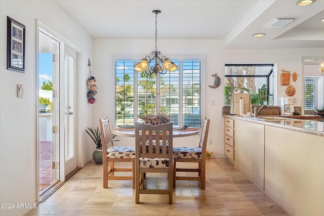 dining room with sink and a chandelier