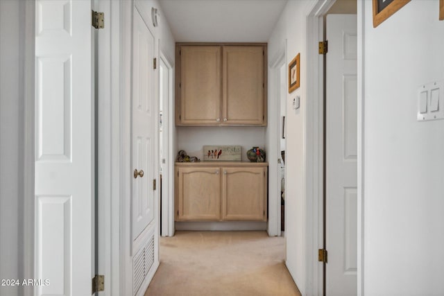 hall with light colored carpet