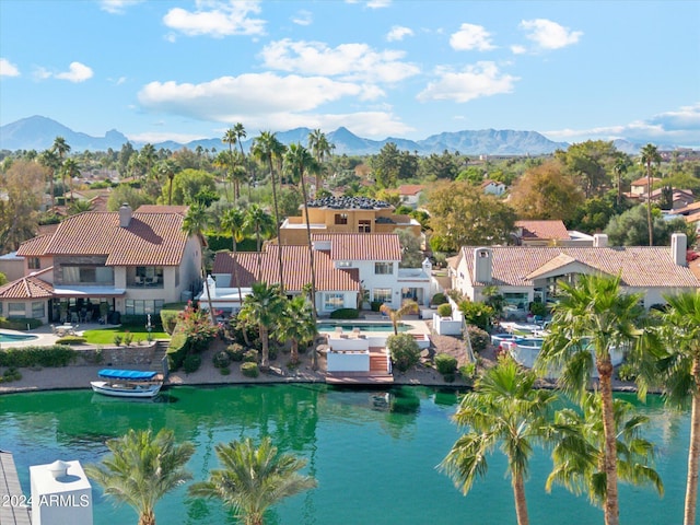 birds eye view of property featuring a water and mountain view