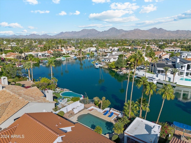 drone / aerial view with a water and mountain view