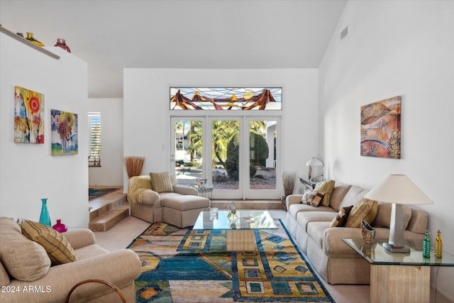 living room with high vaulted ceiling and french doors