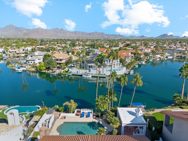 drone / aerial view featuring a water and mountain view