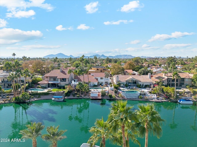 drone / aerial view with a water and mountain view