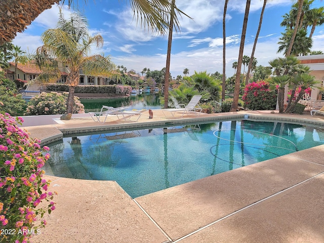 view of swimming pool with a water view