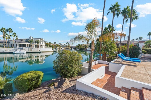 dock area featuring a water view and a patio