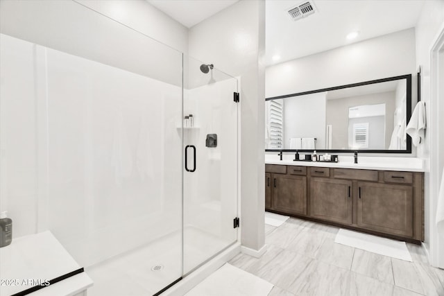 bathroom with an enclosed shower and vanity