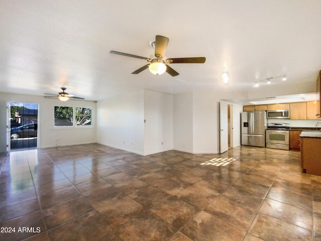 unfurnished living room with ceiling fan