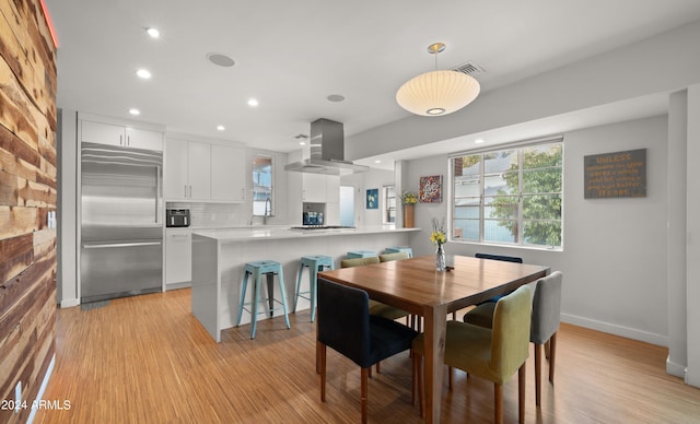 dining space with light hardwood / wood-style flooring