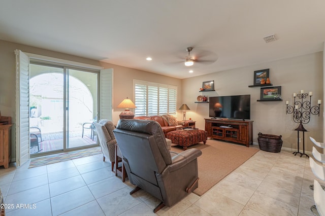 tiled living room with ceiling fan