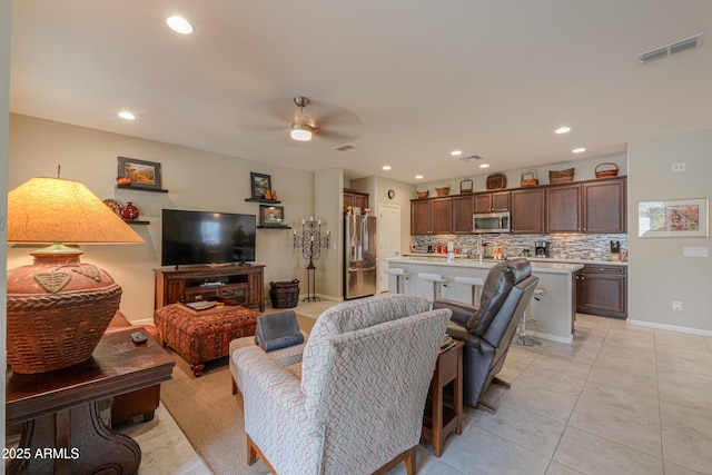 tiled living room with ceiling fan