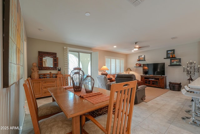 tiled dining area with ceiling fan