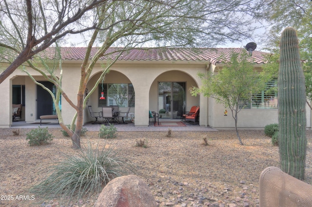 rear view of house with a patio