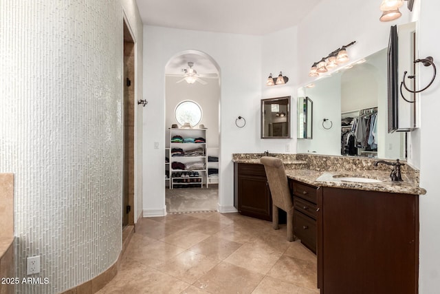 bathroom with tile patterned flooring, vanity, ceiling fan, and walk in shower