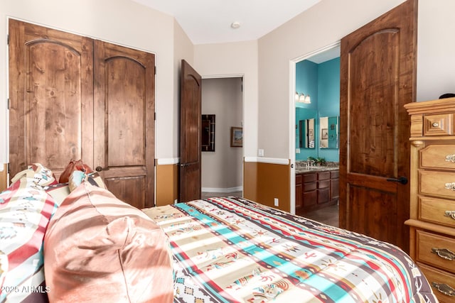 bedroom featuring a closet and ensuite bathroom