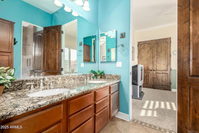 bathroom with ornamental molding, vanity, and tile patterned floors