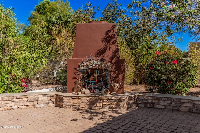 view of patio with an outdoor stone fireplace