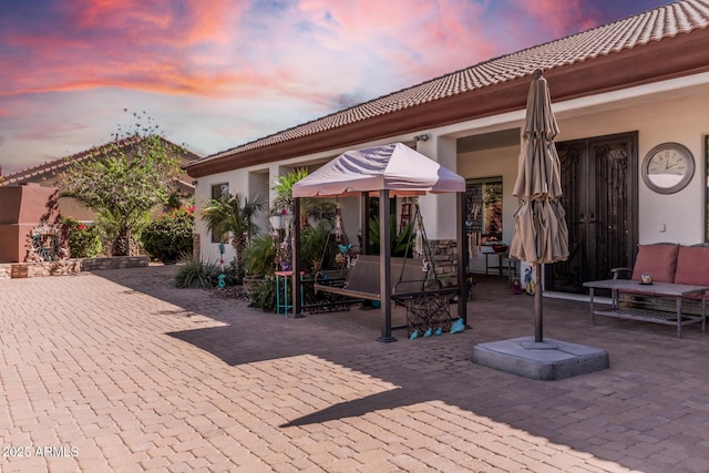 view of patio terrace at dusk