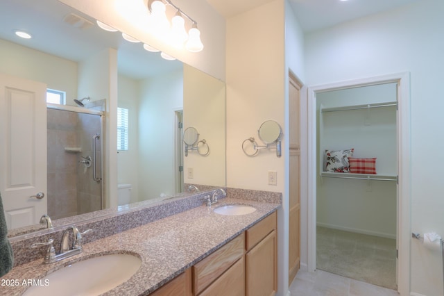 bathroom featuring walk in shower, vanity, tile patterned floors, and toilet