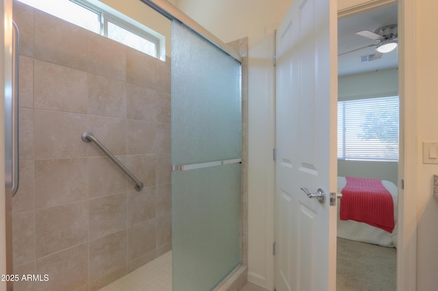 bathroom featuring ceiling fan and a shower with shower door