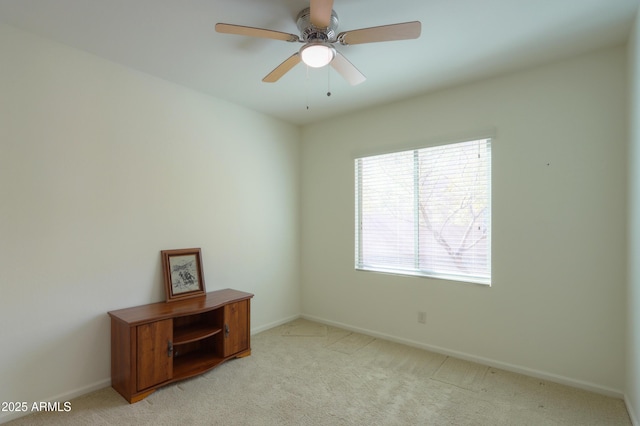 empty room featuring light carpet and ceiling fan