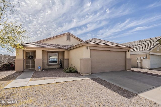 ranch-style home with a tiled roof, an attached garage, driveway, and stucco siding