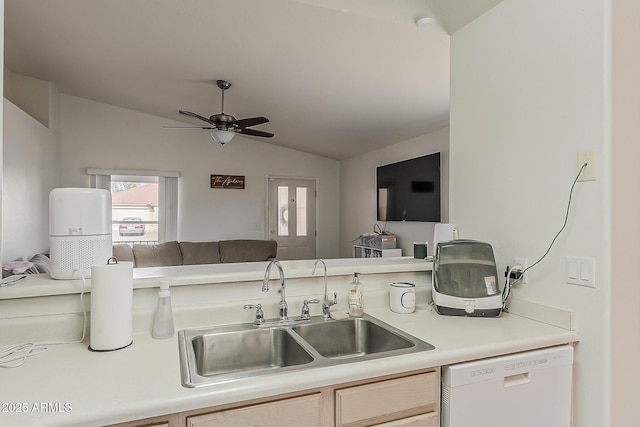 kitchen with lofted ceiling, white dishwasher, open floor plan, light countertops, and a sink