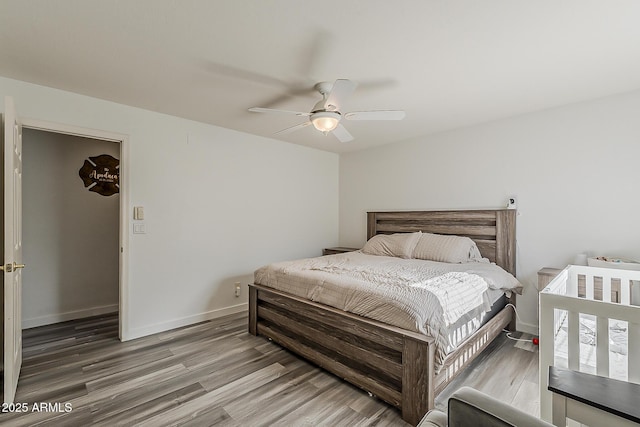 bedroom with baseboards, a ceiling fan, and wood finished floors