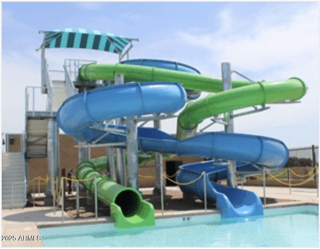 pool featuring a water play area and a water slide