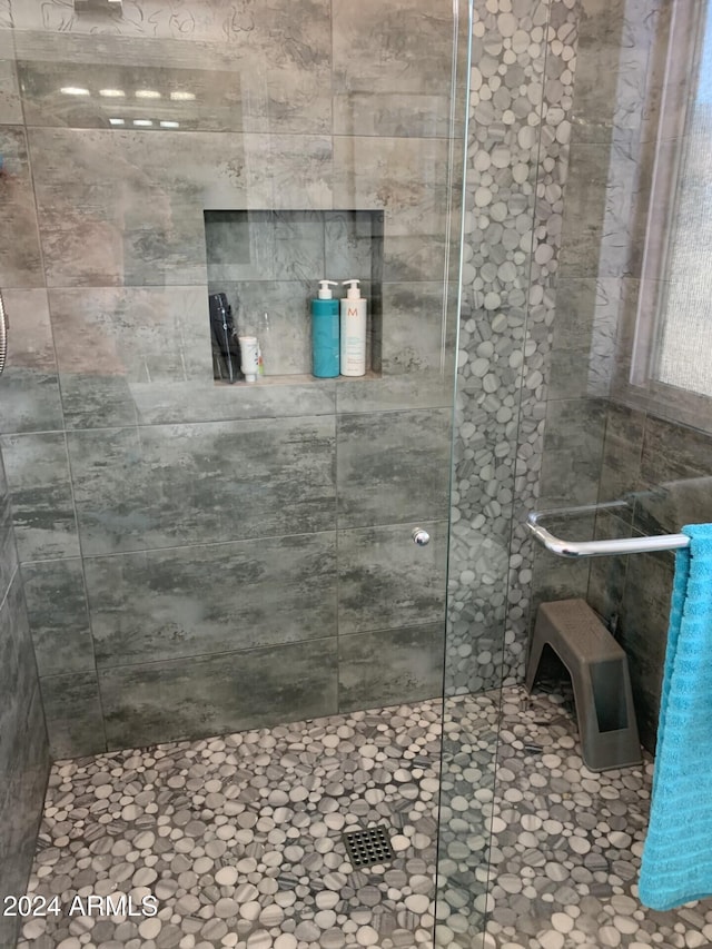 bathroom with a shower with shower door